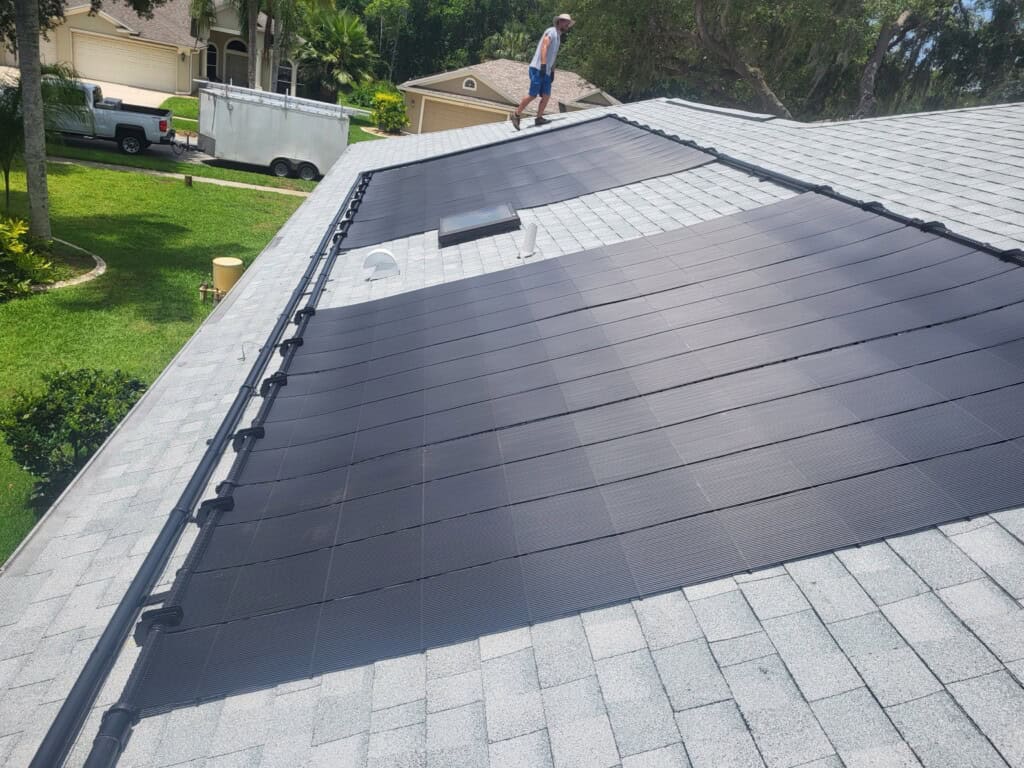 Completed residential solar pool heating installation on a shingle roof