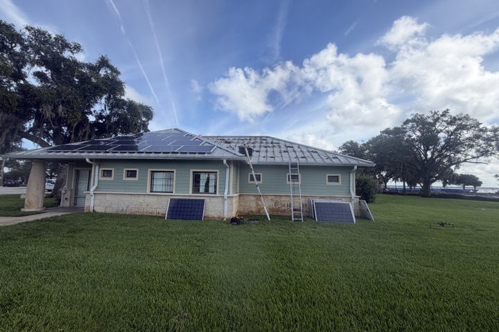 Solar panels being removed and reinstalled during roof work