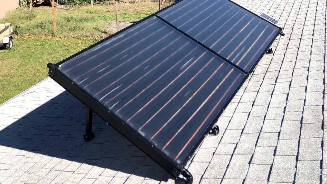 Glazed flat-plate solar water-heating collectors installed on a shingle roof