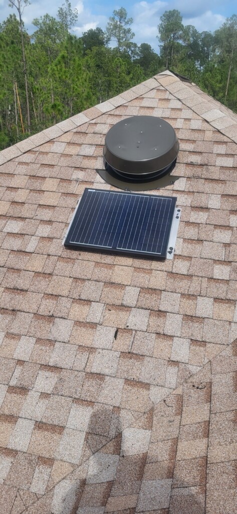 Roof-mounted solar attic fan with separate solar panel