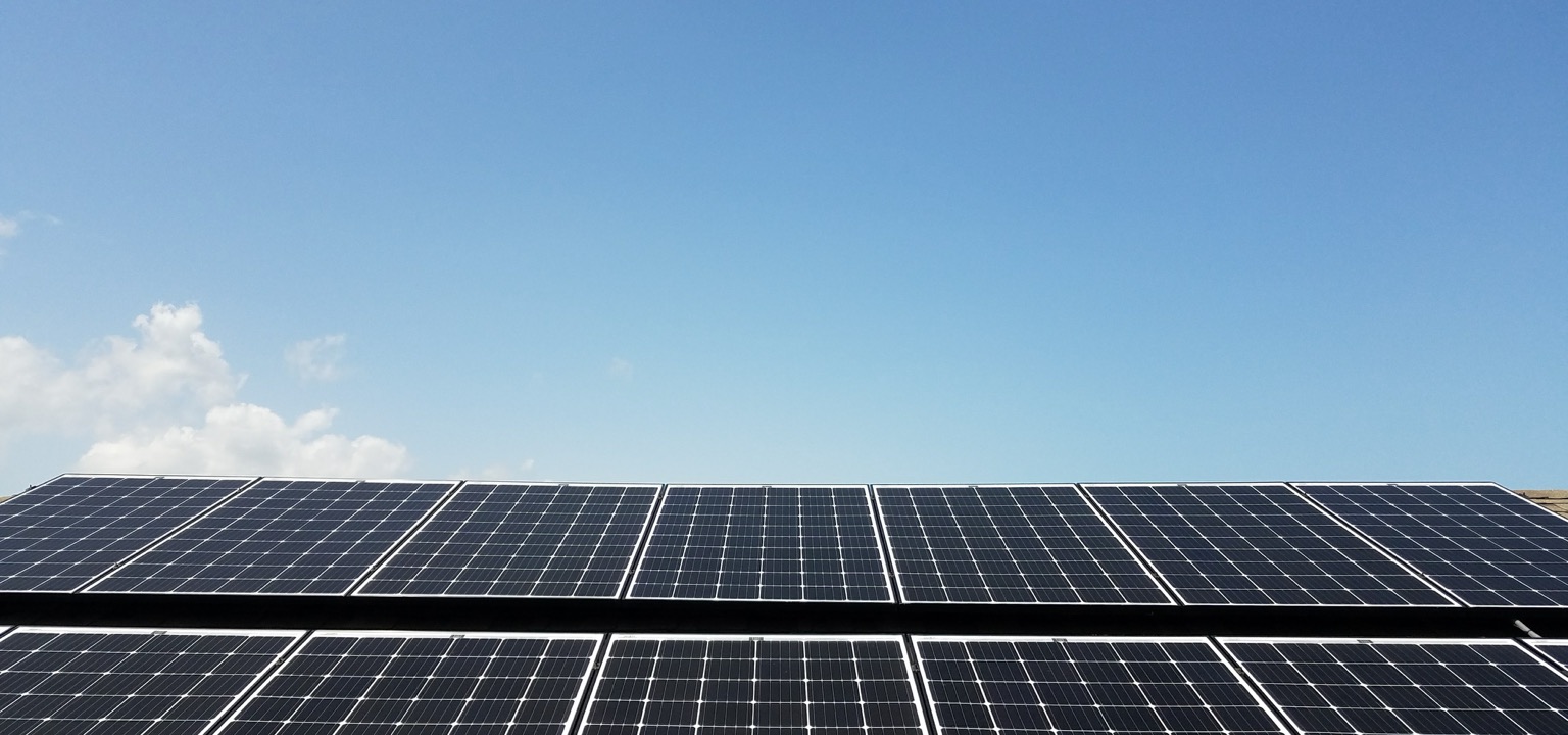 Solar panels installed beneath a clear blue sky
